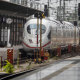 Firefighters walk next to a train at the main station in Frankfurt, Germany, where an 8-year-old boy was run over by a train and killed on Monday. 