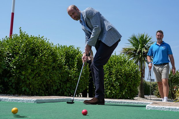 Prince William, Prince of Wales, plays a round of “crazy golf” during a visit to the Hastings Adventure Miniature Golf on July 09, 2026