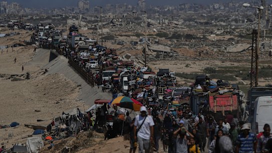 Displaced Palestinians flee Gaza City along the coastal road towards southern Gaza on Wednesday.