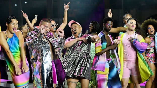 Melbourne designer Erik Yvon (centre, in pink hat) with models at his Australian Fashion Week 2022 show.