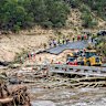 Crews work to clear debris from the Cade Loop bridge along the Guadalupe River on Saturday, July 5.