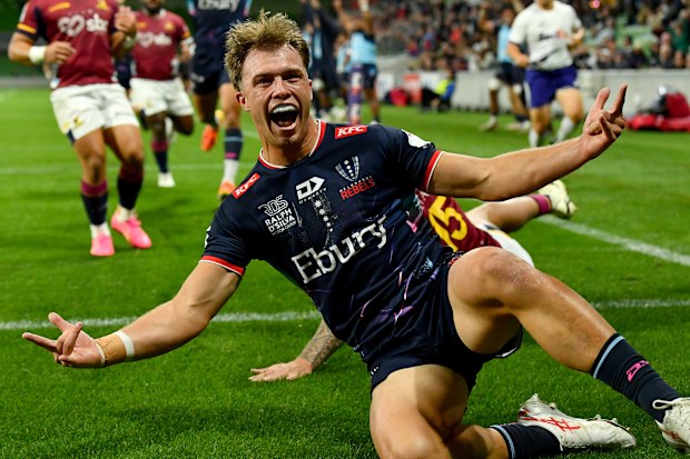 Darby Lancaster of the Rebels celebrates scoring a try.