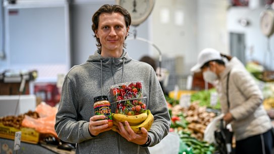 Ukrainian Dmitro Savin shops for fruit and vegetables in Melbourne on Thursday.