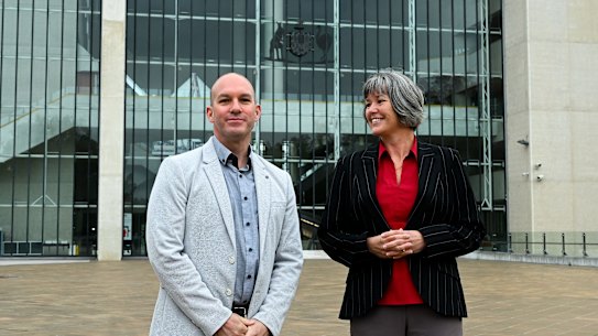 Electric vehicle drivers Chris Vanderstock (left) and Kath Davies outside the High Court.