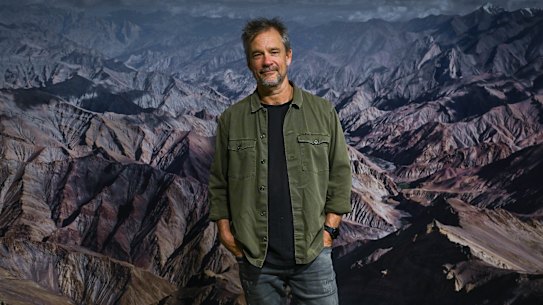 Murray Fredericks stands in front of one of his earliest landscapes, shot in Ladakh.