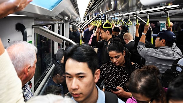 Commuters pack a CBD-bound metro train during the morning peak.
