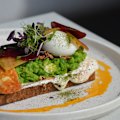 Smashed peas on toast with citrus labne, pickled beets, puffed wild rice, halloumi, chilli oil and poached egg at Yolk Group cafe Tinker in Melbourne’s Northcote.