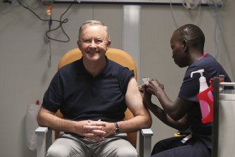 Opposition Leader Anthony Albanese receives a COVID-19 vaccination from registered nurse Yom Mapiou .