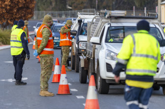 Australian Army soldiers assist New South Wales Police Officers at the Wodonga Place border control point in Albury.