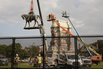 Crews remove a towering statue of Confederate General Robert E. Lee in Richmond, Virginia, the ex-capital of the Confederacy.