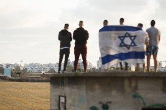 Israelis gather to watch the Iron Dome missile defence system launch to intercept rockets fire from the Gaza Strip.