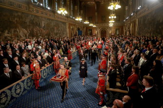 Prince Charles, Camilla, Duchess of Cornwall and Prince William proceed behind the Imperial State Crown through the Royal Gallery.