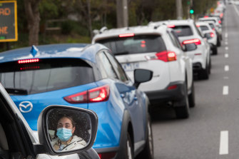 A long line of people in cars waiting for a COVID-19 test on Hampstead Road in Melbourne’s north west. 