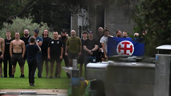 White supremacists pose with the flag of the Australian European Movement at Elwood Beach.