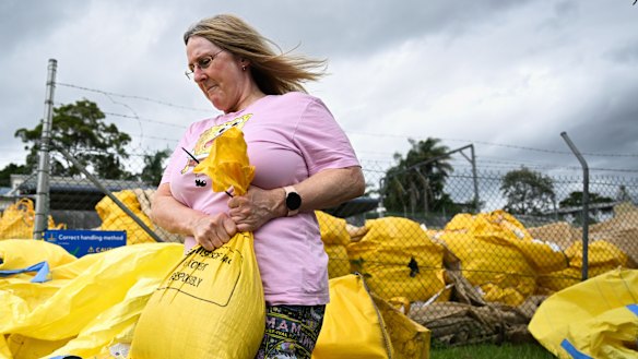 Residents collect sandbags from a council depot in Morningside on Monday.