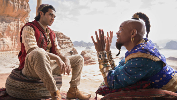 Mena Massoud (left) as Aladdin and Will Smith as Genie in Disney's Aladdin.