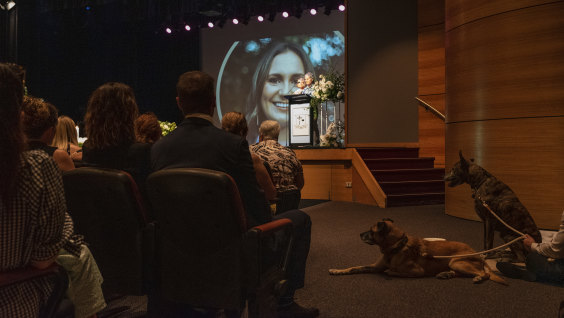 Family, friends and pets Frankie and Django watch on during the service on Monday. 