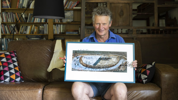 Braidwood farmer Martin Royds holds an artwork by John Wolseley depicting his moated dam concept.