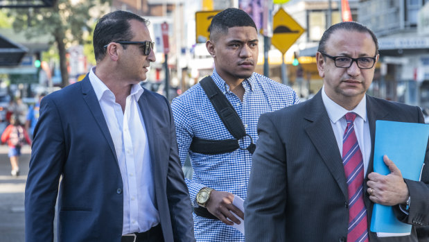 Manase Fainu (centre) arriving at Liverpool police station on October 29 with manager Mario Tartak (left) and legal representative Elias Tabchouri.