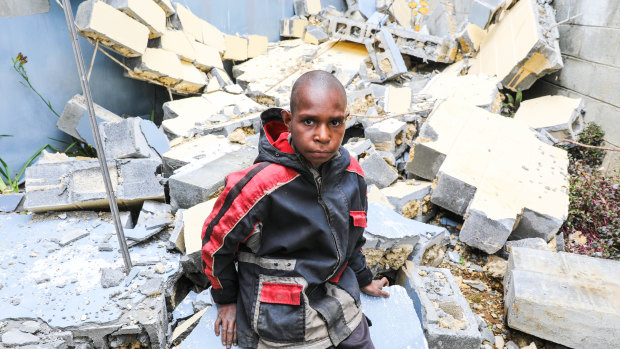 Abel Jeffery, 10, at the damaged Mendi School of Nursing, where 5 buildings were seriously damaged in the February earthquakes. 