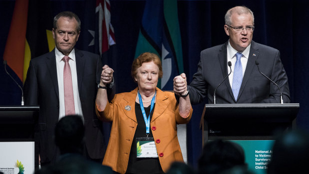 Opposition Leader Bill Shorten and Prime Minister Scott Morrison joined hands with Cheryl Edwardes, the chairwoman of the National Apology Reference Group.