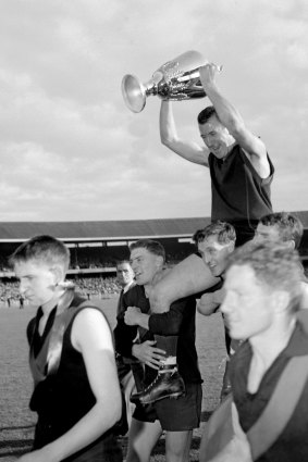 John Beckwith holds aloft the 1959 premiership cup.