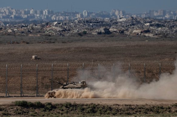 An Israeli tank moves through an area near the Israeli-Gaza border, as seen from southern Israel.