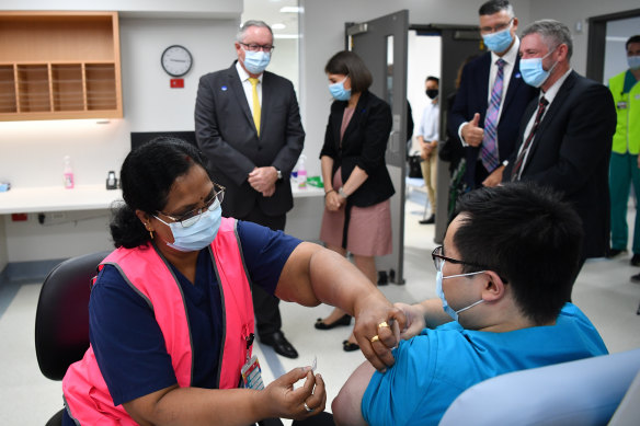 NSW Premier Gladys Berejiklian and Health Minister Brad Hazzard look on as a NSW Health worker receives his COVID-19 vaccination at the Westmead Hospital.