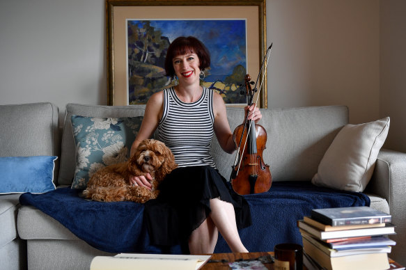 Violinist Madeleine Easton, who will play at the coronation of King Charles at Westminster Abbey in London in May, seen with her dog Rosie in Sydney on Thursday.
