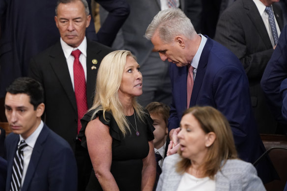 Representative Marjorie Taylor Greene, known for conspiracy theories, talks to Representative Kevin McCarthy during the vote for House Speaker on the opening day at the US Capitol.