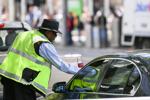 A Melbourne City Council ranger issues a parking ticket in 2016.