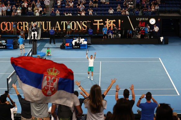 Novak Djokovic waves to the crowd after beating Aslan Karatsev.