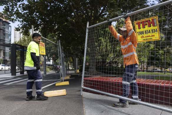Workers install a fence around Harmony Park in Surry Hills to close it to the public after the dangerous friable asbestos was found in the park .