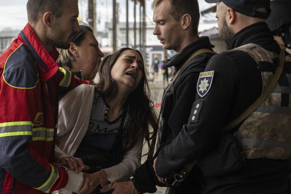 A woman, Sabina, cries after her husband Artem Pogorelets was killed by Russian shelling at Barabashovo market in Kharkiv, Ukraine, on Thursday, July 21.