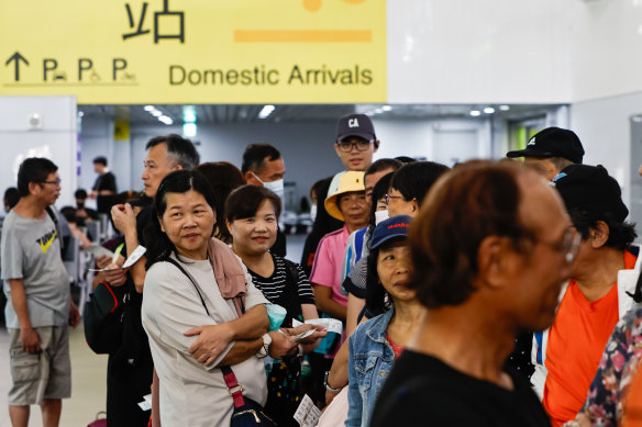 People wait for flights bound for outlying islands as the PLA hold military exercises in nearby waters. 