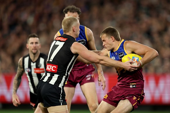 Ty Gallop of the Lions is tackled by Billy Frampton of the Magpies.