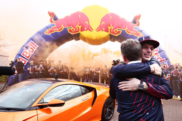 Max Verstappen embraces Red Bull team boss Christian Horner.