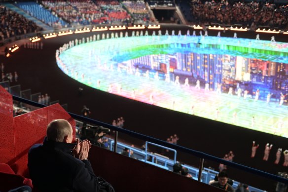 Russian President Vladimir Putin claps during the Beijing Winter Olympics opening ceremony. 