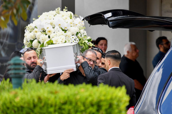 Simon Tadros (right), husband of helicopter crash victim Vanessa Tadros, helps carry her casket to the hearse during her funeral at St John the Beloved Church in Sydney on Monday.