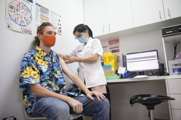 Health worker and student Max Eberle receives a booster vaccination in Parramatta on Thursday.