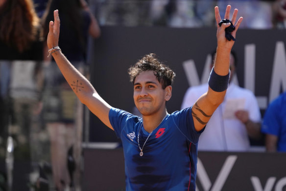 Alejandro Tabilo celebrates his victory over Novak Djokovic.
