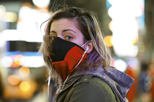 Brooklyn waitress Casey Stewart peers out from a ski mask she adapted to protect herself from coronavirus after riding the subway to Times Square.