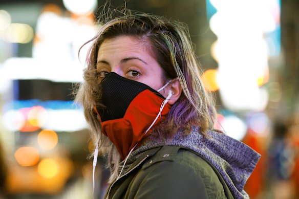 Brooklyn waitress Casey Stewart peers out from a ski mask she adapted to protect herself from coronavirus after riding the subway to Times Square.