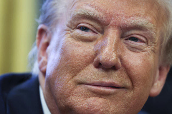 President Donald Trump listens in the Oval Office at the White House in Washington.