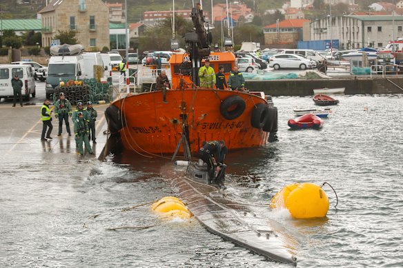 The Spanish civil guard tows a sunken submarine believed to be carrying tonnes of cocaine.