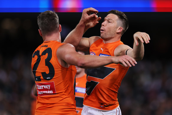 Jesse Hogan and Toby Greene of the Giants celebrate a goal.