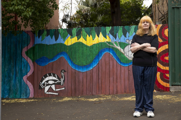 Darlington local Winsome Evans stands next to a mural painted by Darlington Primary School students