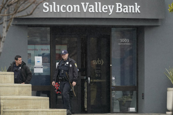 Police officers exit Silicon Valley Bank in Santa Clara on Friday.