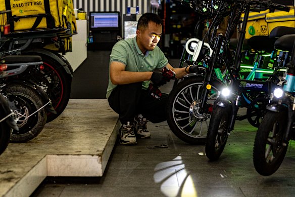 Yifang Cao at work at his e-bike dealership in Burwood.