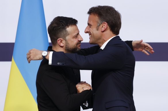 French President Emmanuel Macron hugs Ukrainian President Volodymyr Zelensky in Paris.